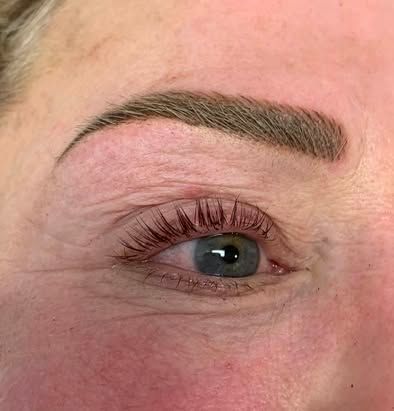 Close-up of a face showing a neatly shaped eyebrow and eye with pink skin around it