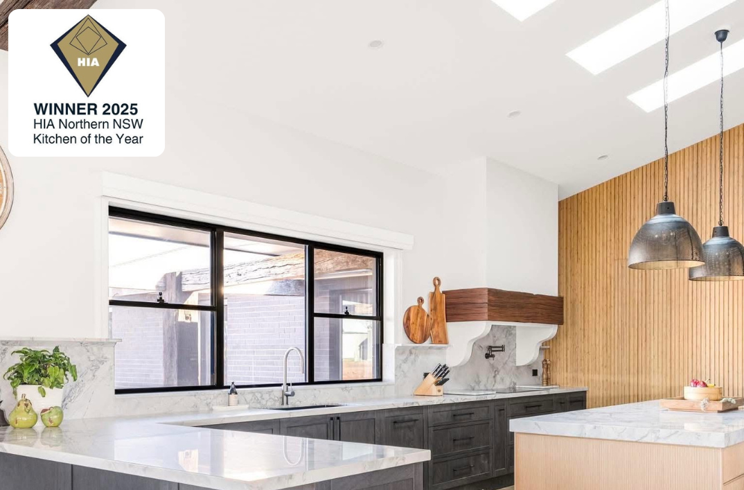 A Kitchen with granite tops and different colour wood cabinets — Content Stone In Trenayr, NSW