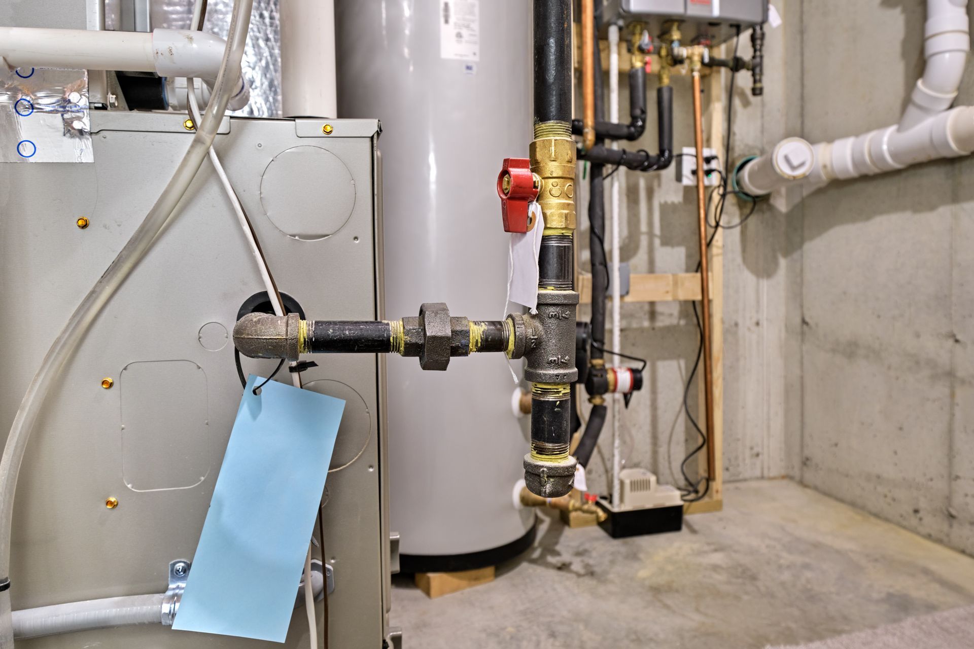 There is a water heater in the basement of a house.