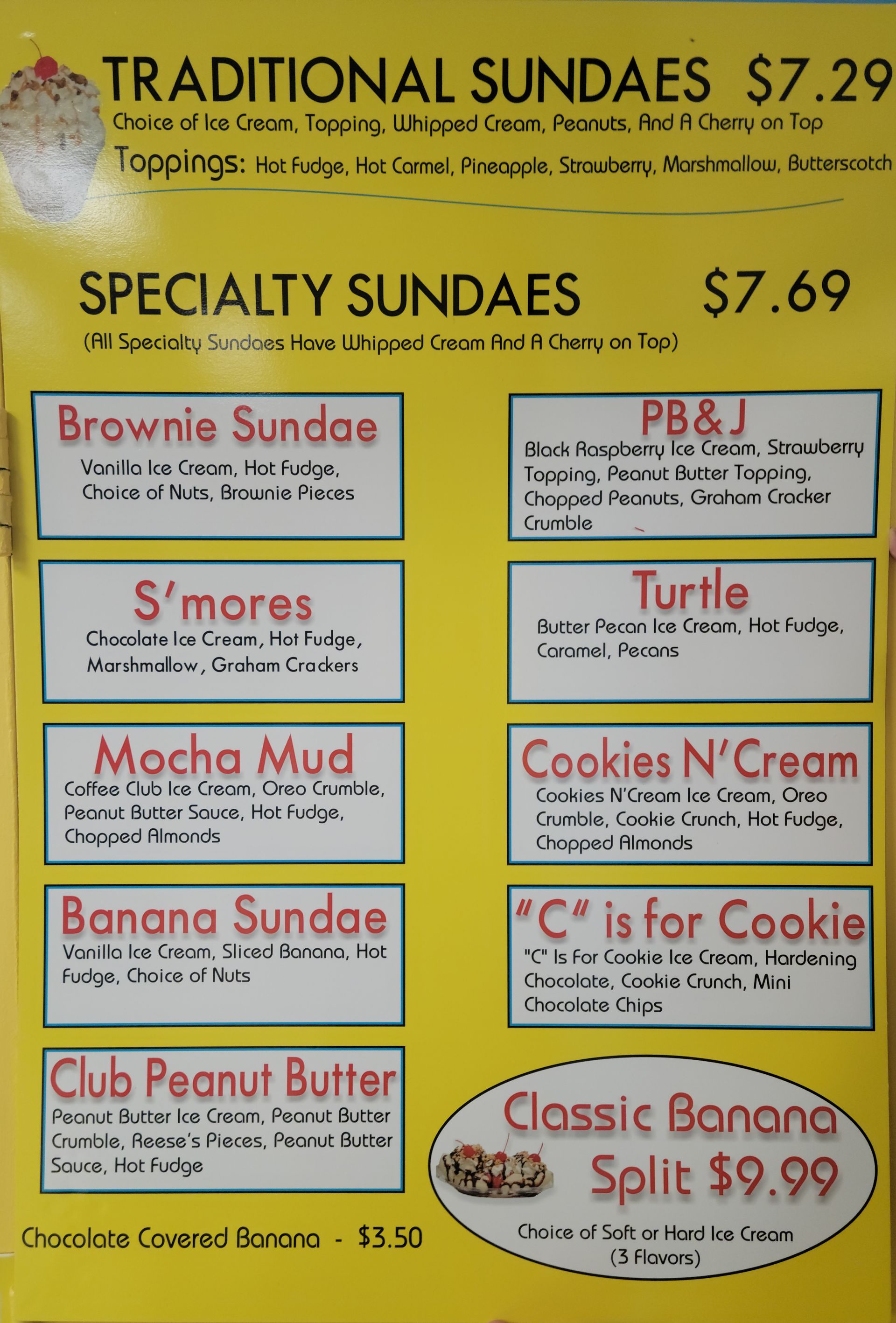 Menu board for ice cream sundaes, yellow background, various flavors listed, price $7.69-$9.99.