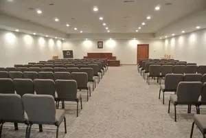 There are rows of chairs in a large room.