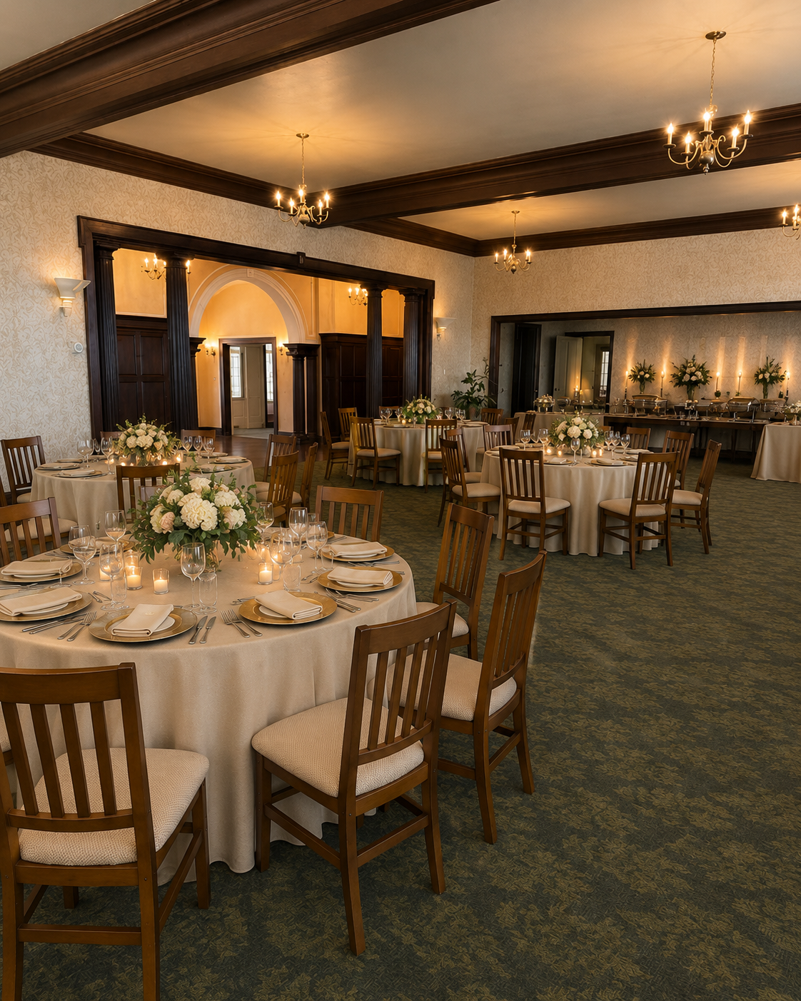 Elegant banquet hall with round, candlelit tables, white tablecloths, and wooden chairs under warm lighting.