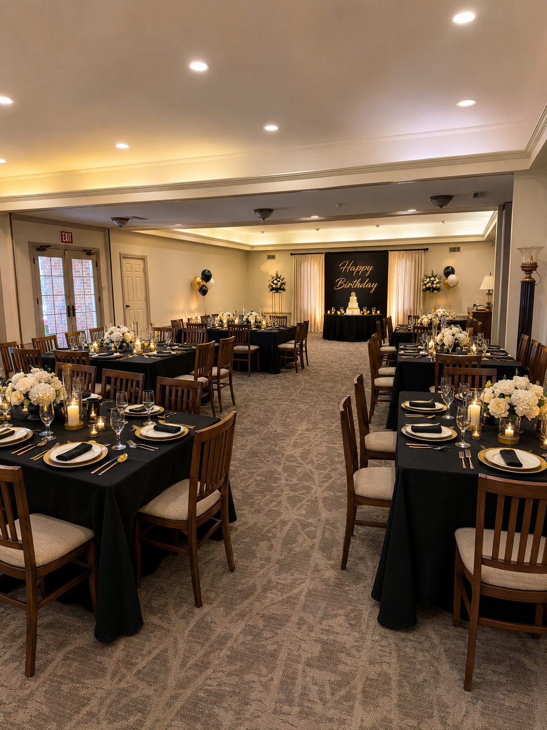 Elegant banquet hall with black-draped tables and warm ceiling lights, set for an event.