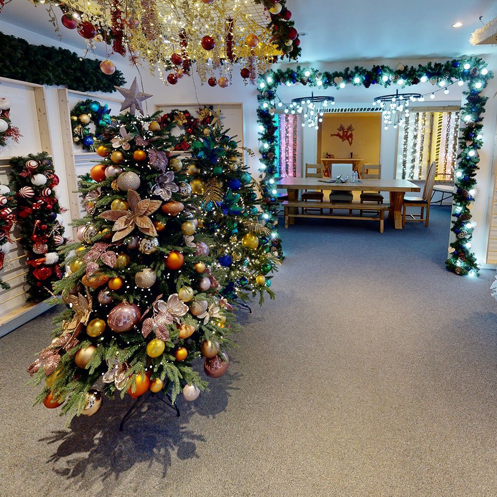 A Christmas tree theme showroom with baubles, garlands and wreaths.