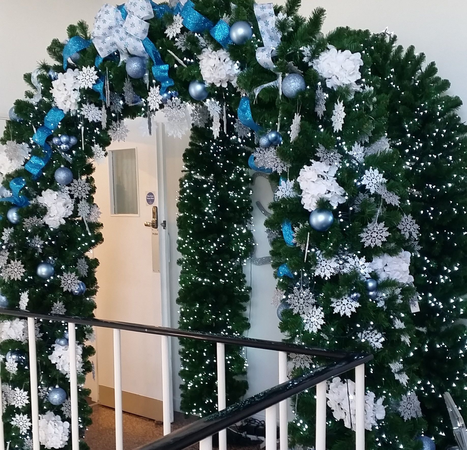 A doorway decorated with christmas decorations and snowflakes.
