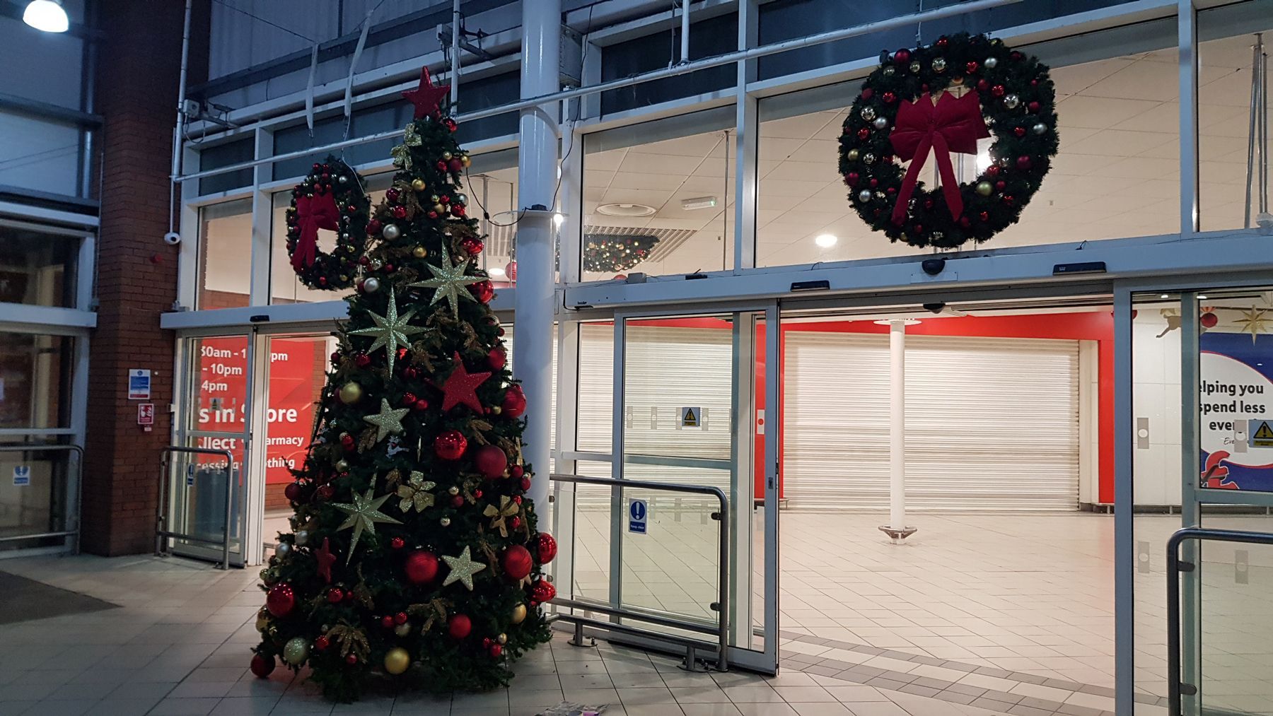 There is a christmas tree in the middle of a building.