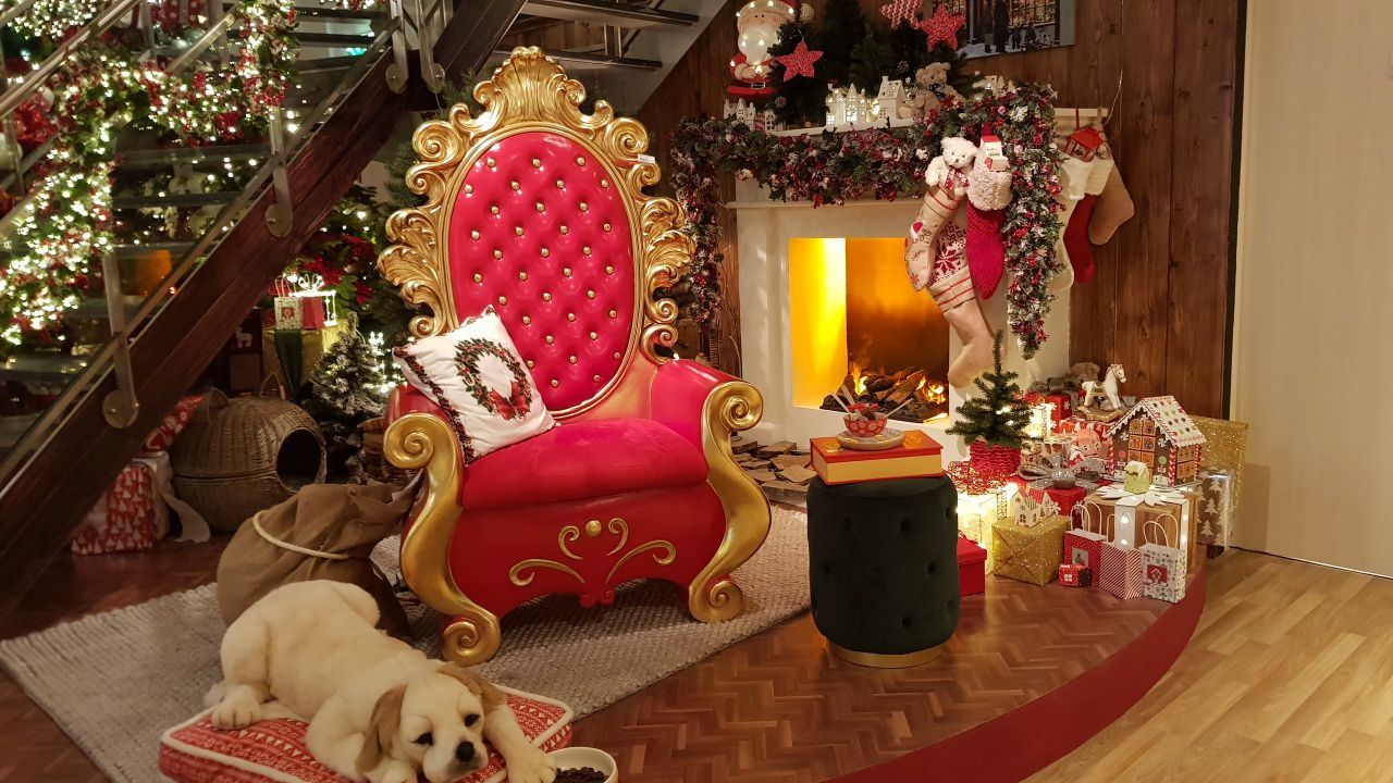 A santa claus chair in front of a fireplace.