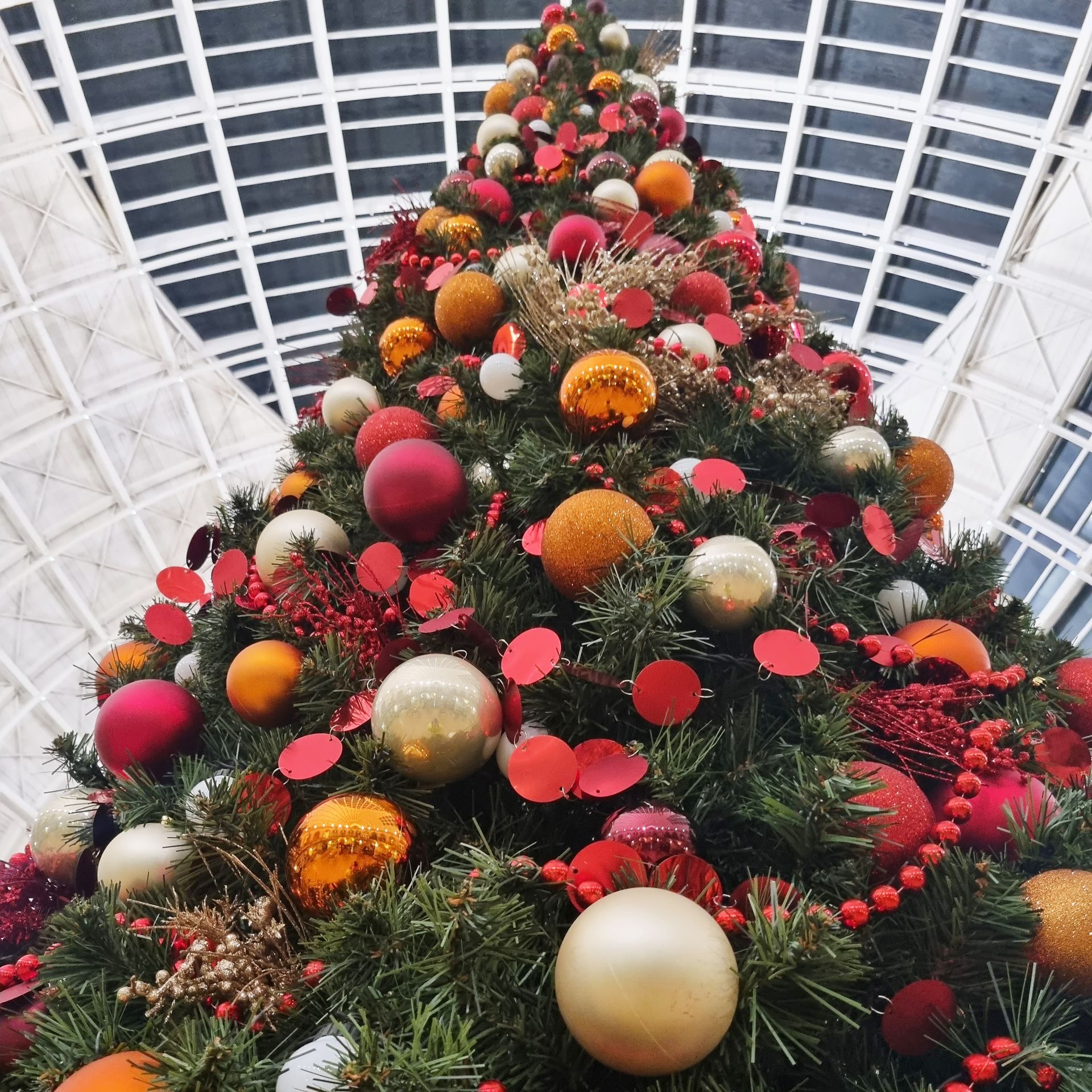 A large christmas tree with lots of decorations on it.