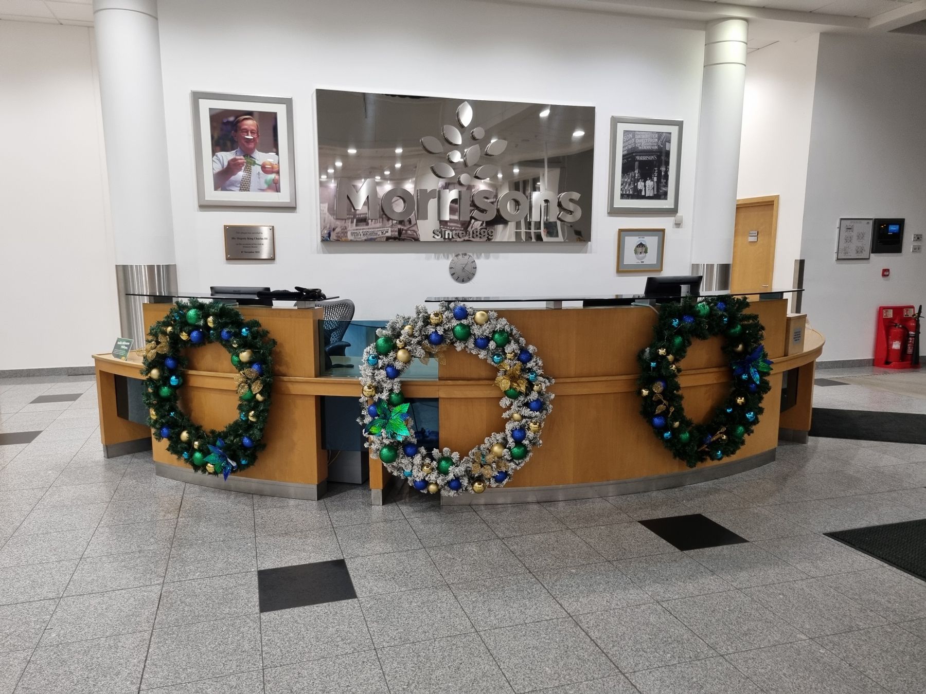 A reception desk with christmas wreaths on it.