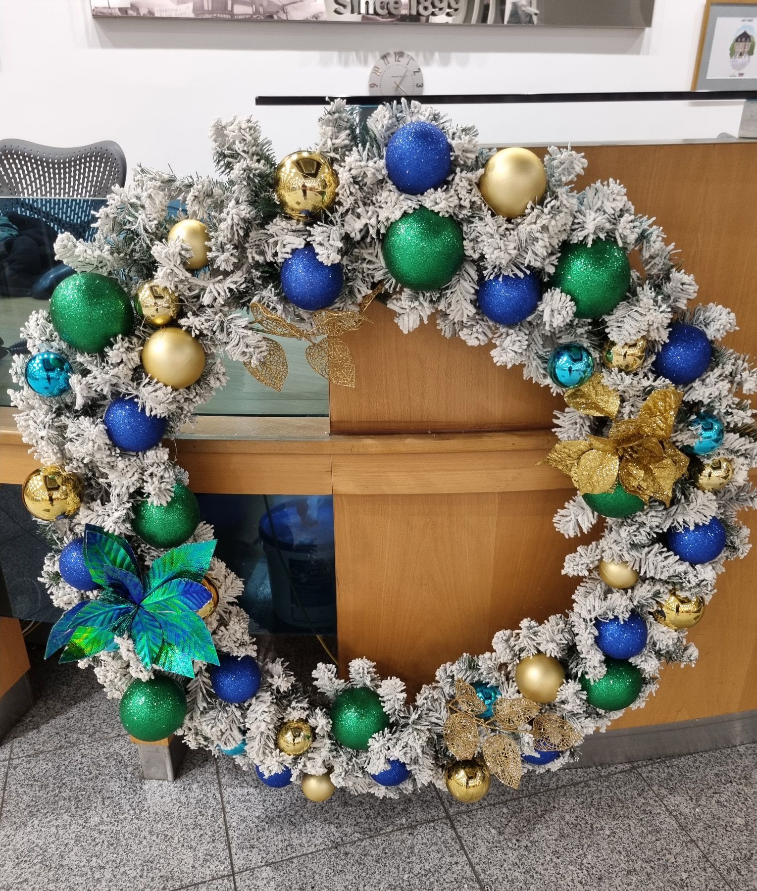 Blue and green peacock themed white frosted wreath