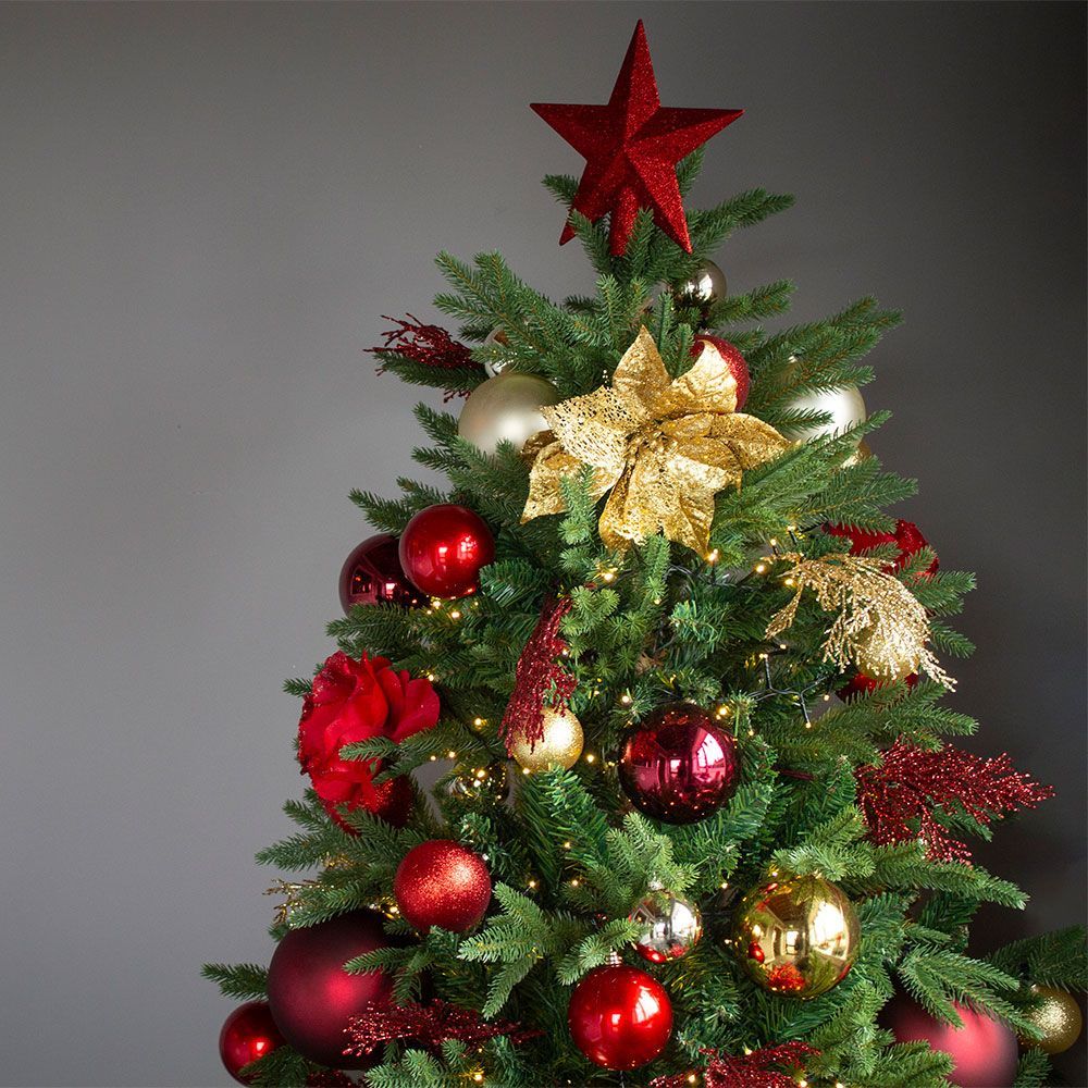 A christmas tree with red and gold decorations and a red star on top