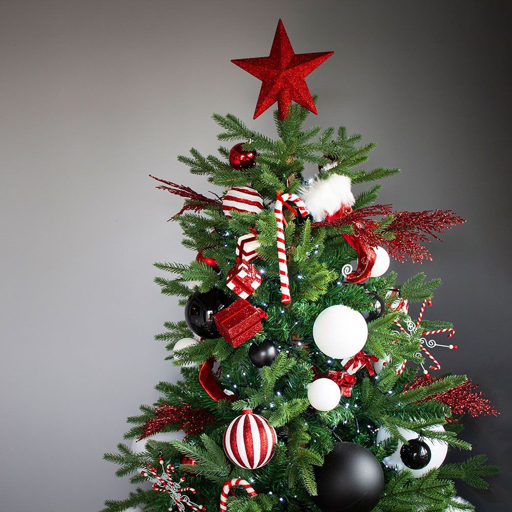 A christmas tree with red and white ornaments and a red star on top