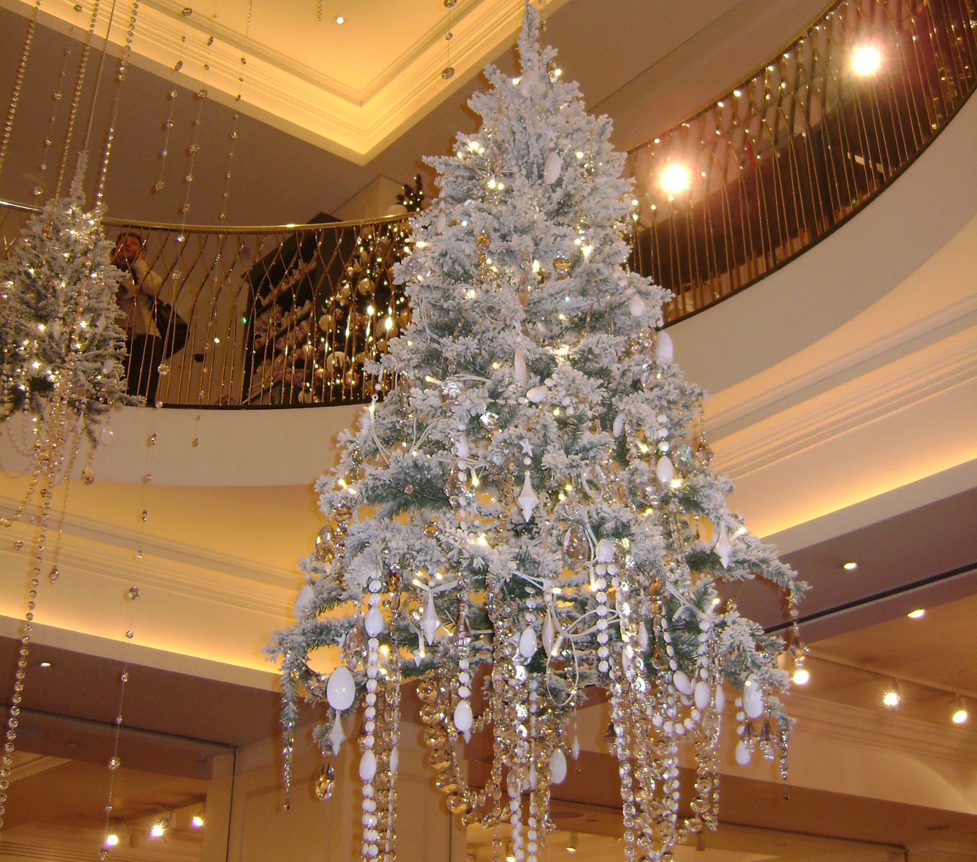 A large white christmas tree is hanging from the ceiling.