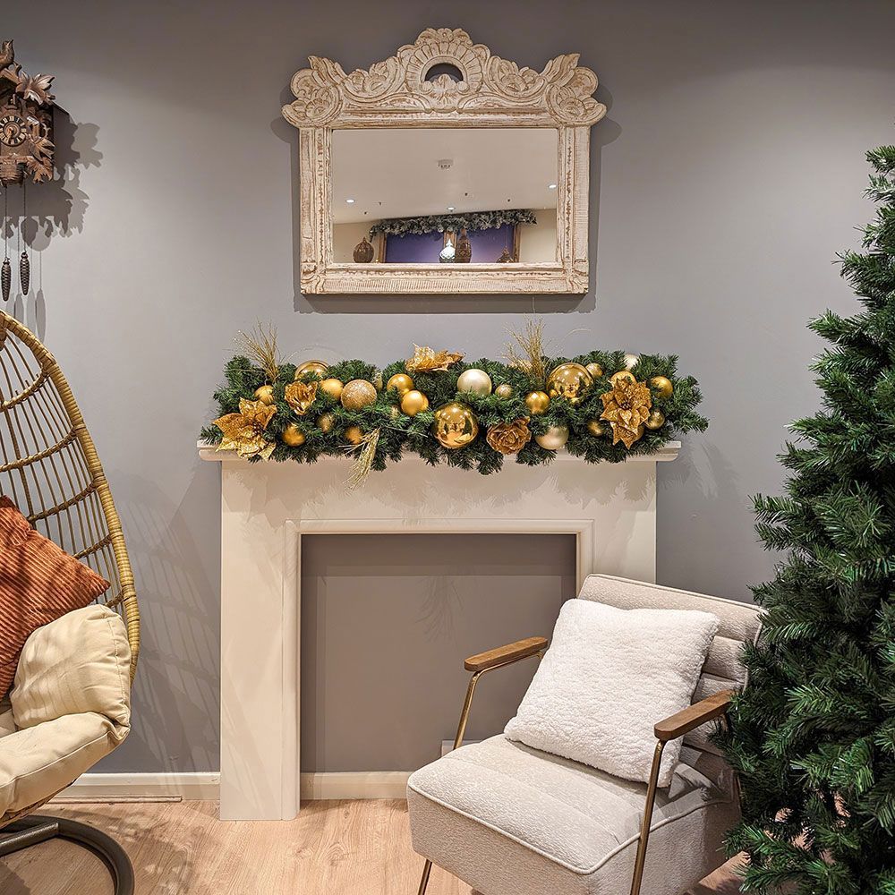 A living room with a chair and a christmas garland.