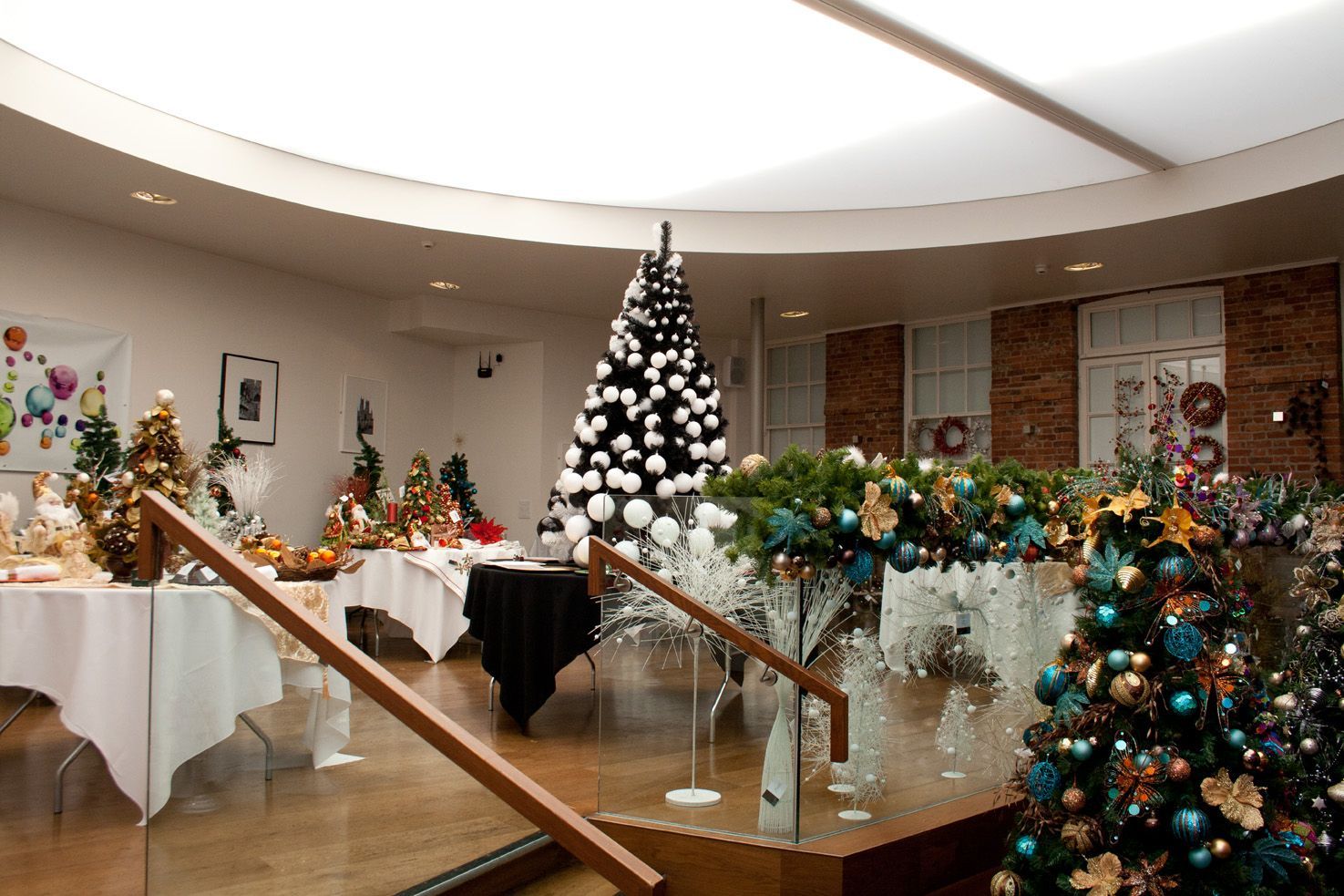 A room filled with christmas trees and tables.