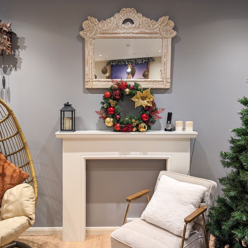 A living room with a chair and a christmas tree.