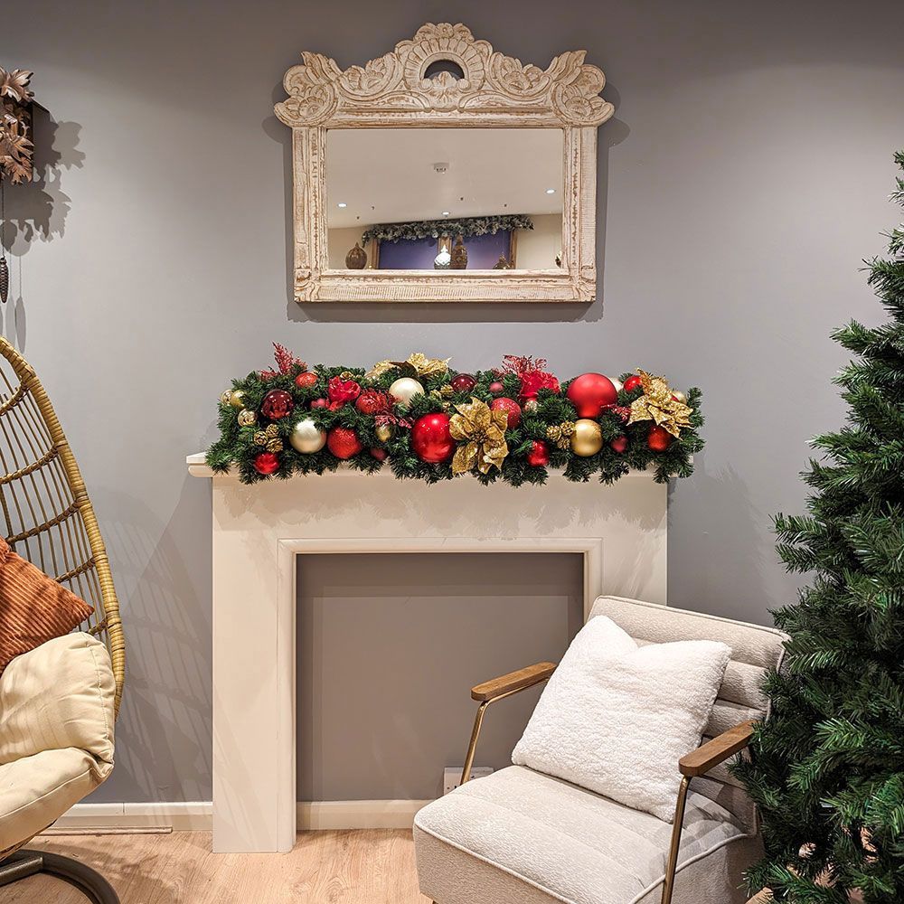 A living room with a chair and a christmas tree.