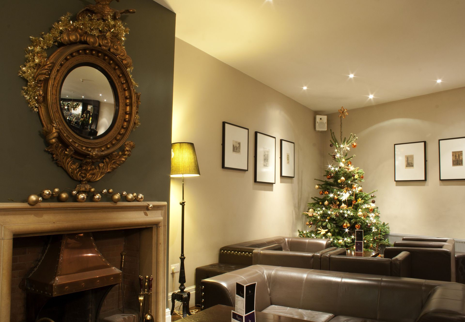 A living room with a fireplace and a christmas tree.