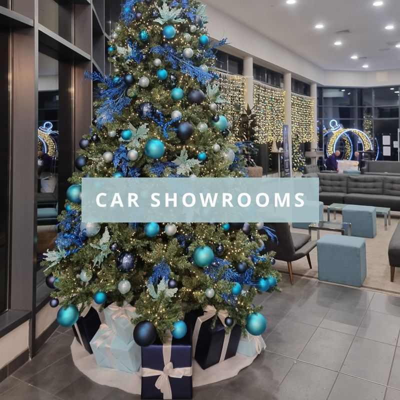 A car showroom with a christmas tree in the middle with the words car showrooms over the top.