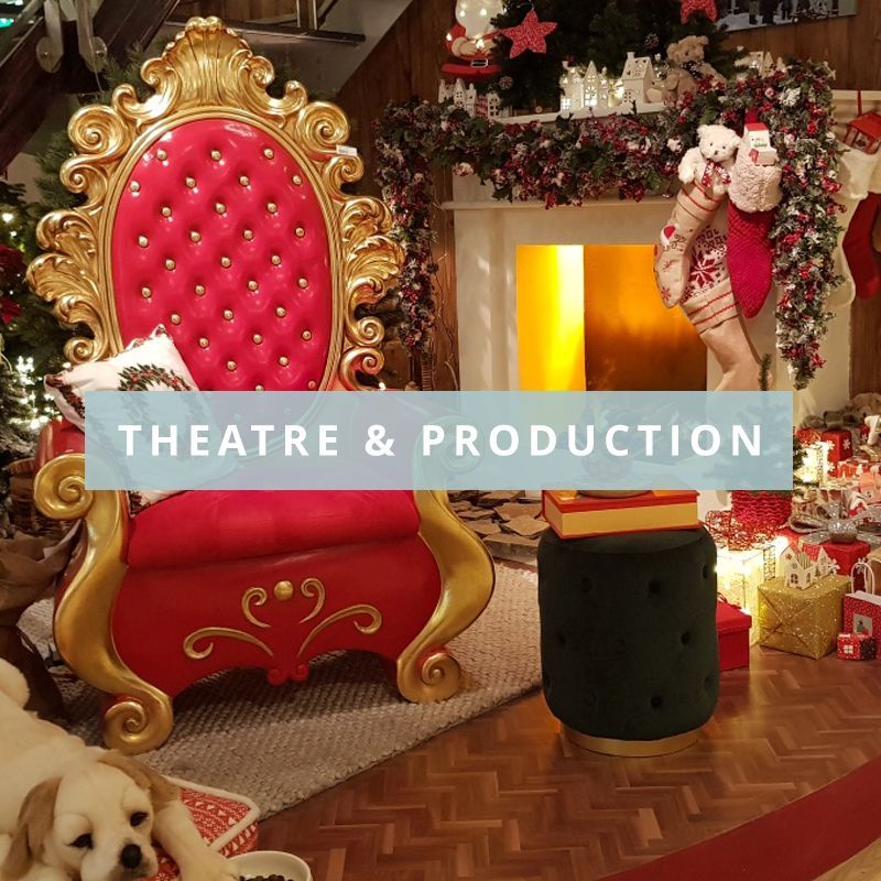 A red and gold santa claus chair is in a living room with the words theatre & production over the top.