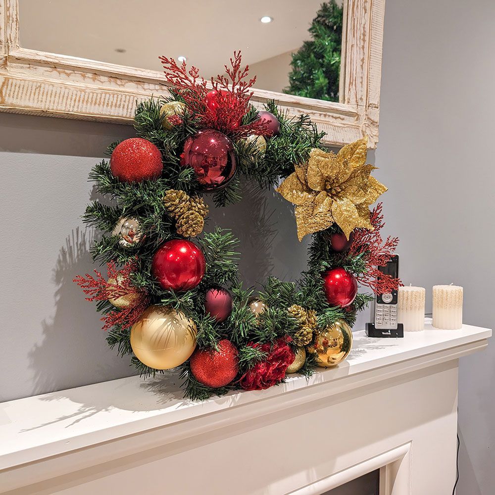 Decorated Christmas tree beside two gray chairs in a small gray room