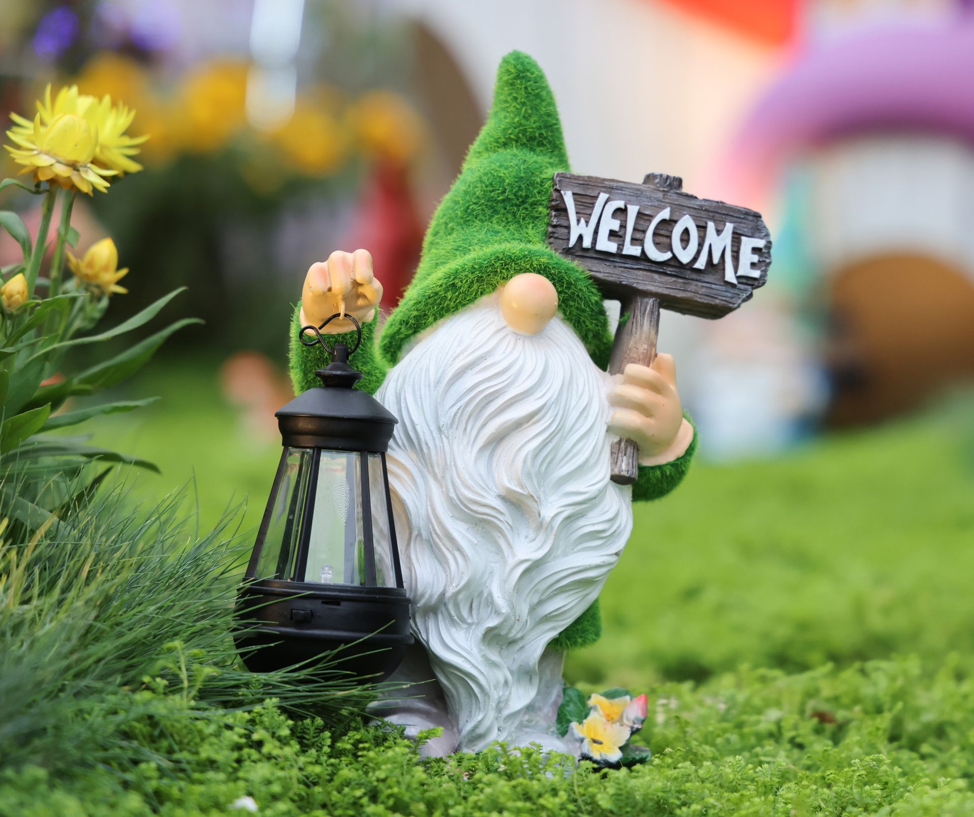 Nome in yard holding "Welcome" sign and a lantern.