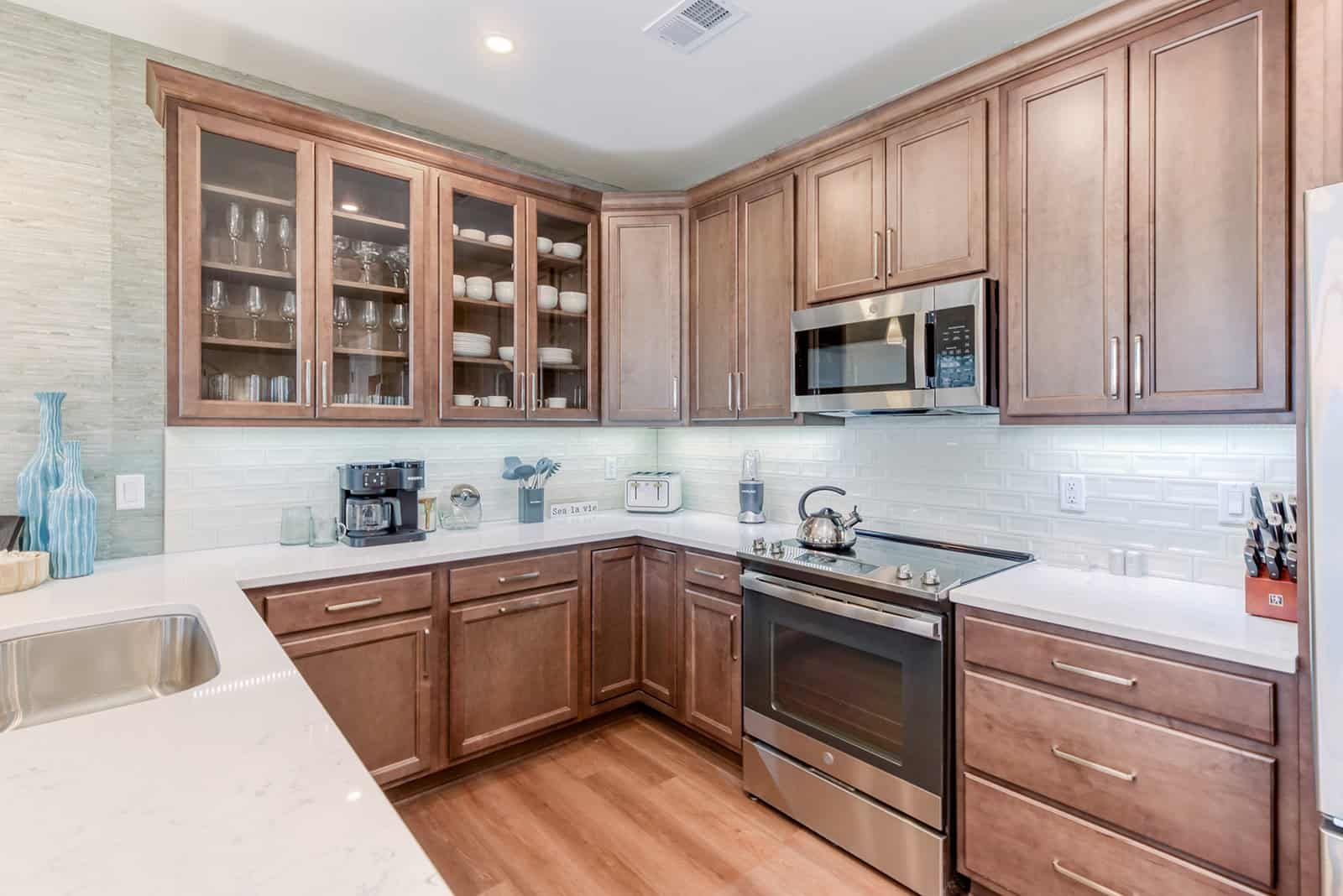 Kitchen with stainless steel appliances and wood cabinets at Hamilton Cay Reserve in Kill Devil Hills, Outer Banks NC