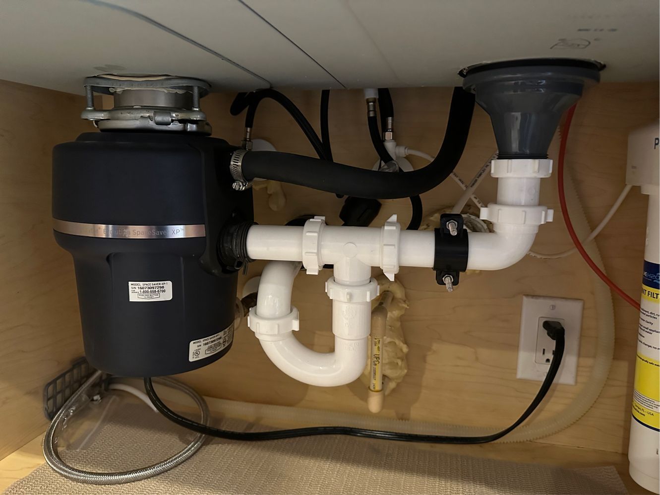 A sink with a garbage disposal underneath it