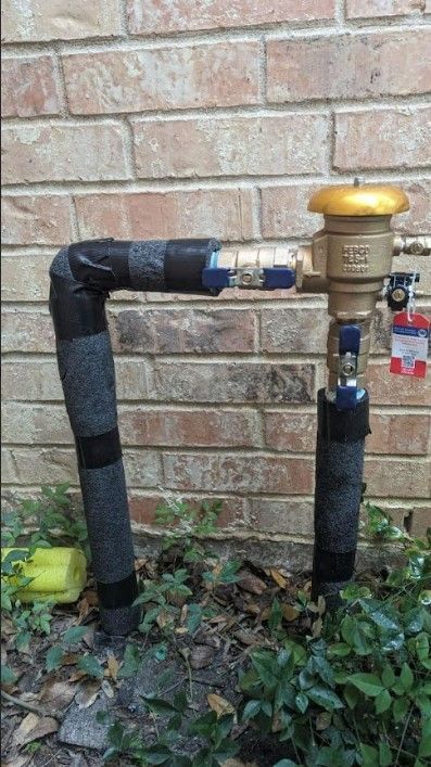 A water pipe is sitting in front of a brick wall.