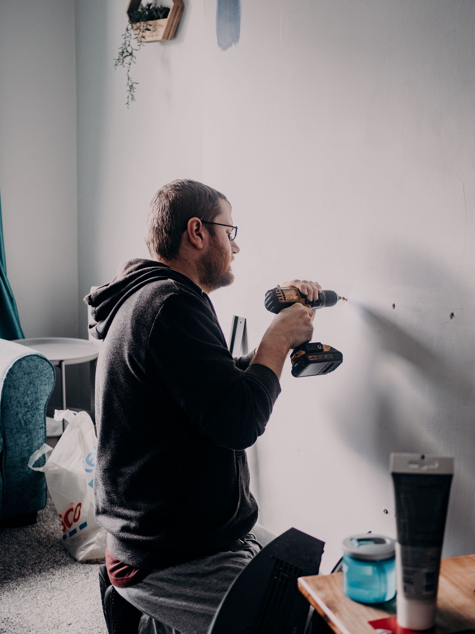 Handyman completing a light repair inside a home.
