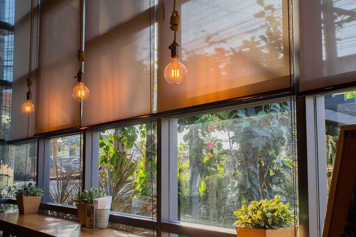 A restaurant with a lot of windows and blinds.