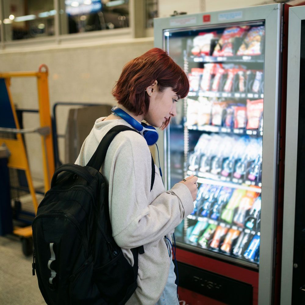 Woman Looking at The Vending Machine — Orange Park, FL — Northeast Florida Vending Inc