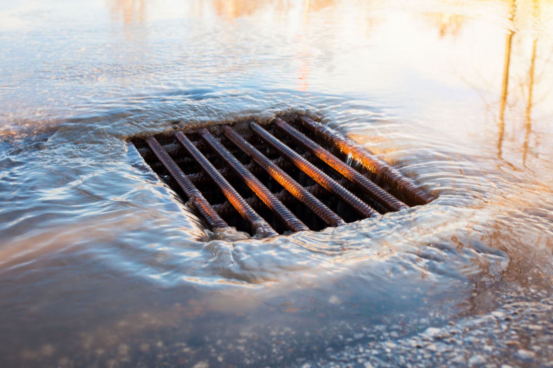 A drain with water coming out of it.