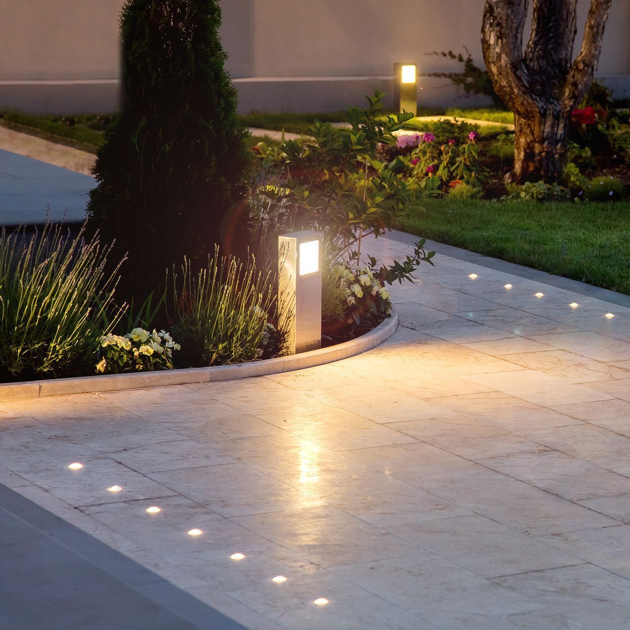 A brick walkway with a few lights on it