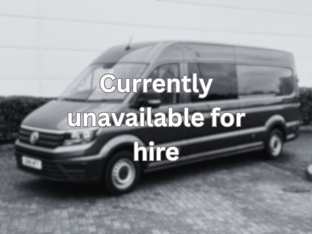 Unavailable for hire A volkswagen crafter van is parked in a parking lot in front of a building.