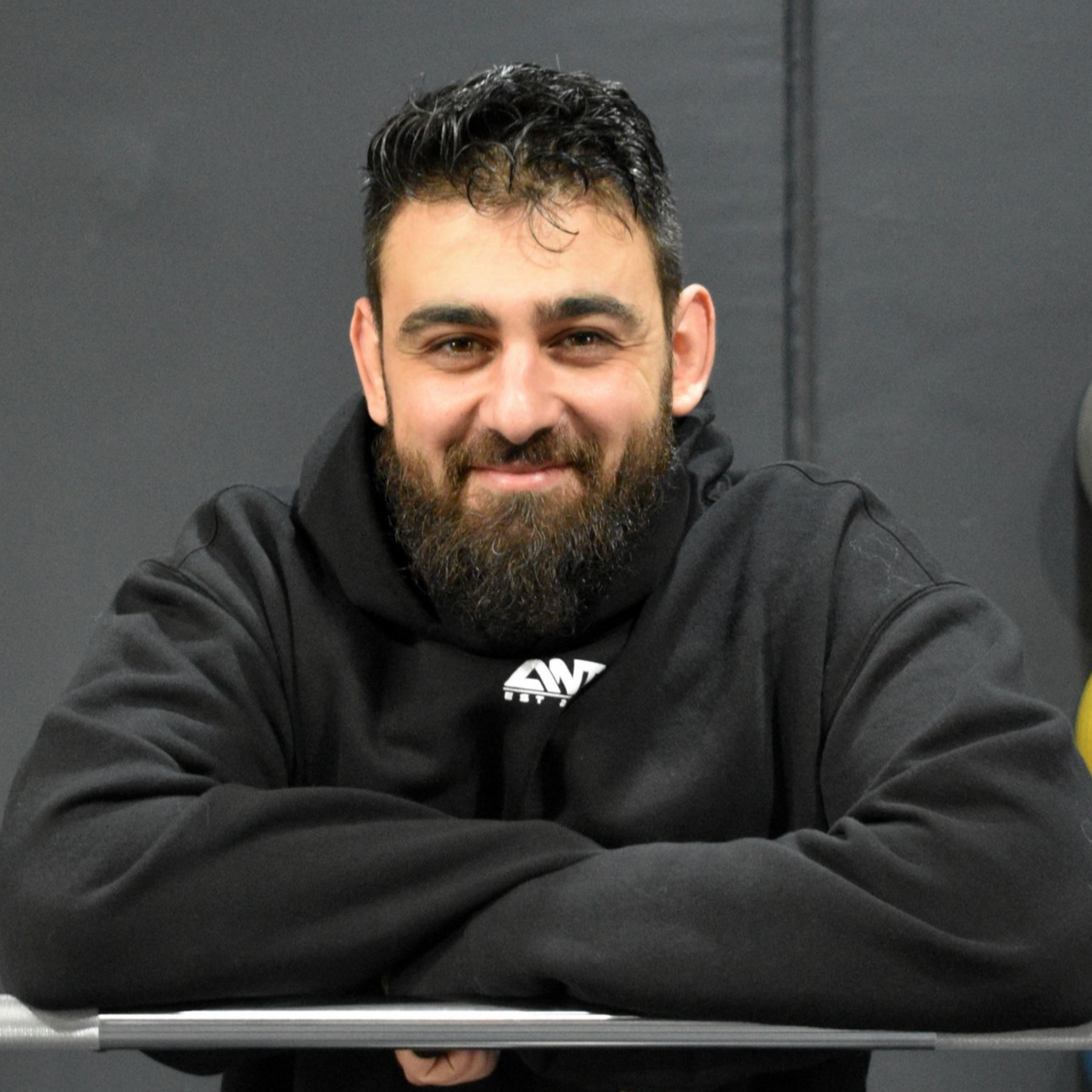 A man wearing a black ant altona north training sweatshirt
