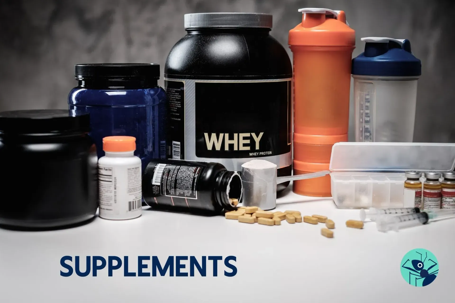 A bottle of whey protein surrounded by other supplements on a table.