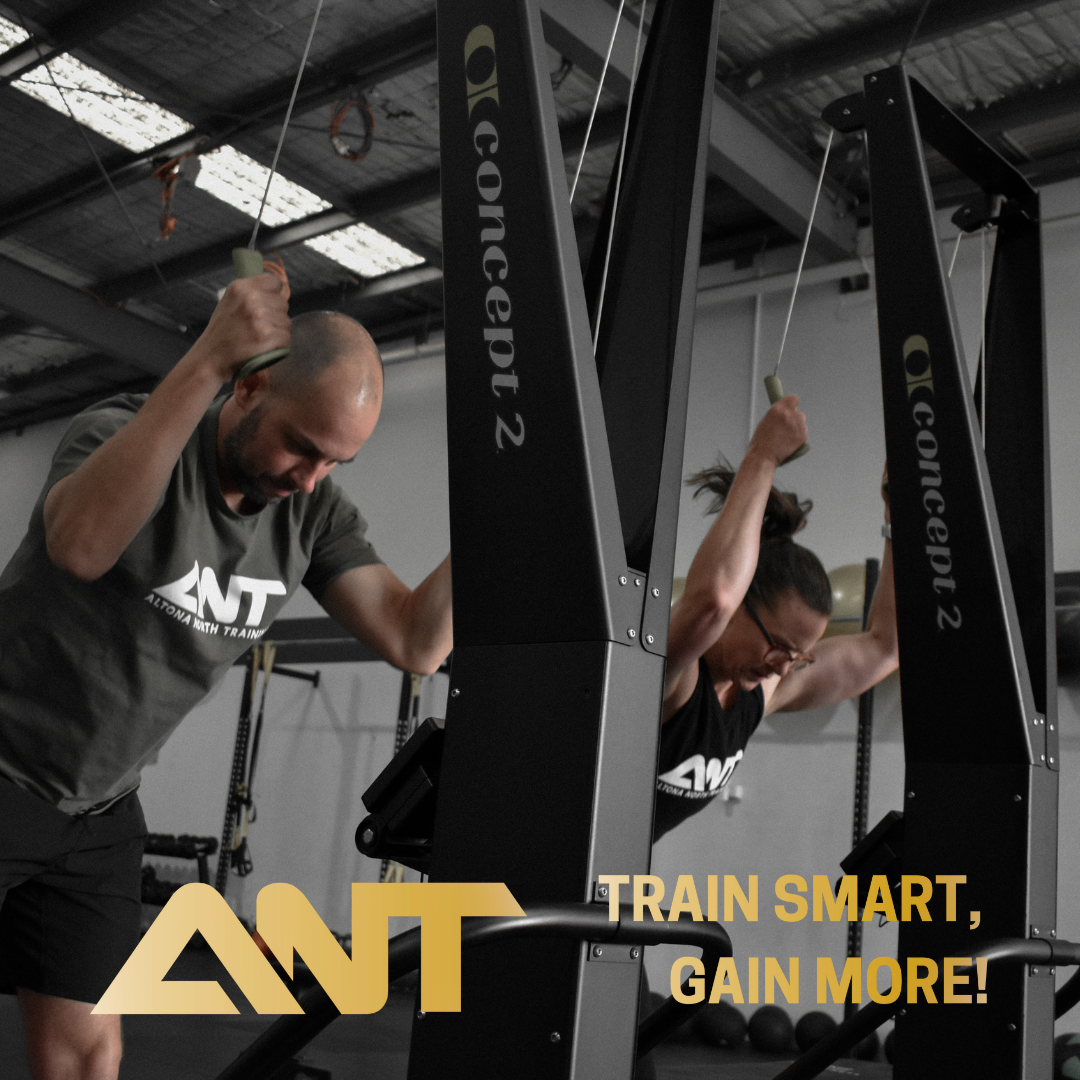 A man and a woman are doing exercises on a concept 2 machine