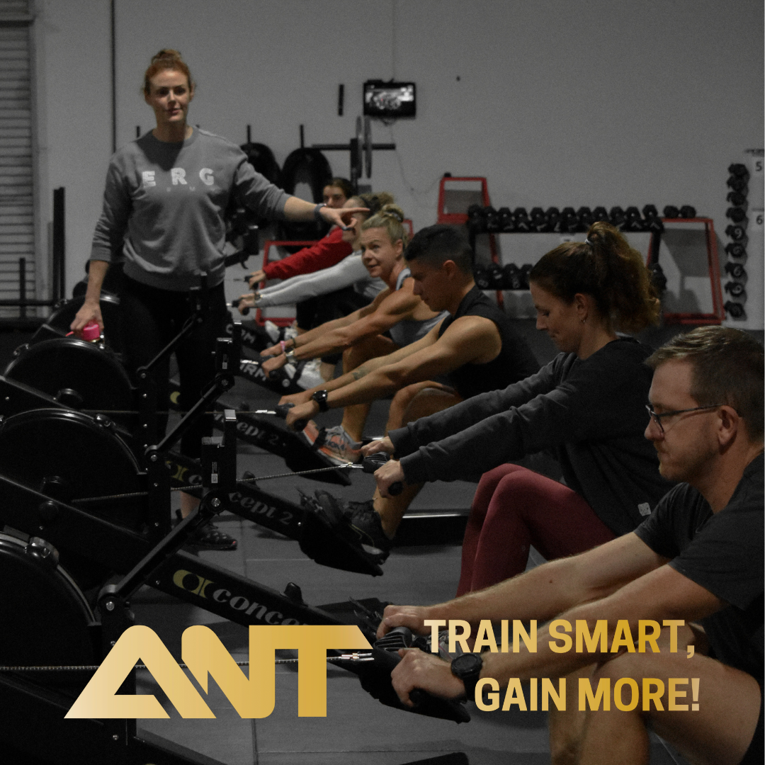 A group of people are rowing in a gym with the words train smart gain more