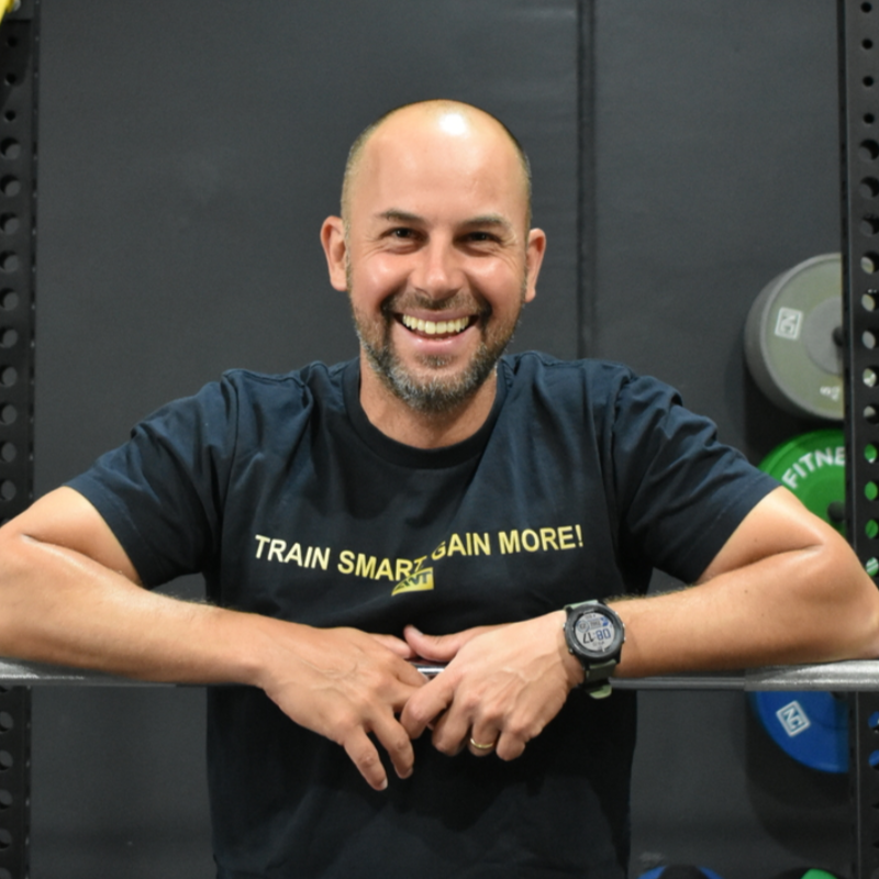 A man wearing a green shirt that says ant on it