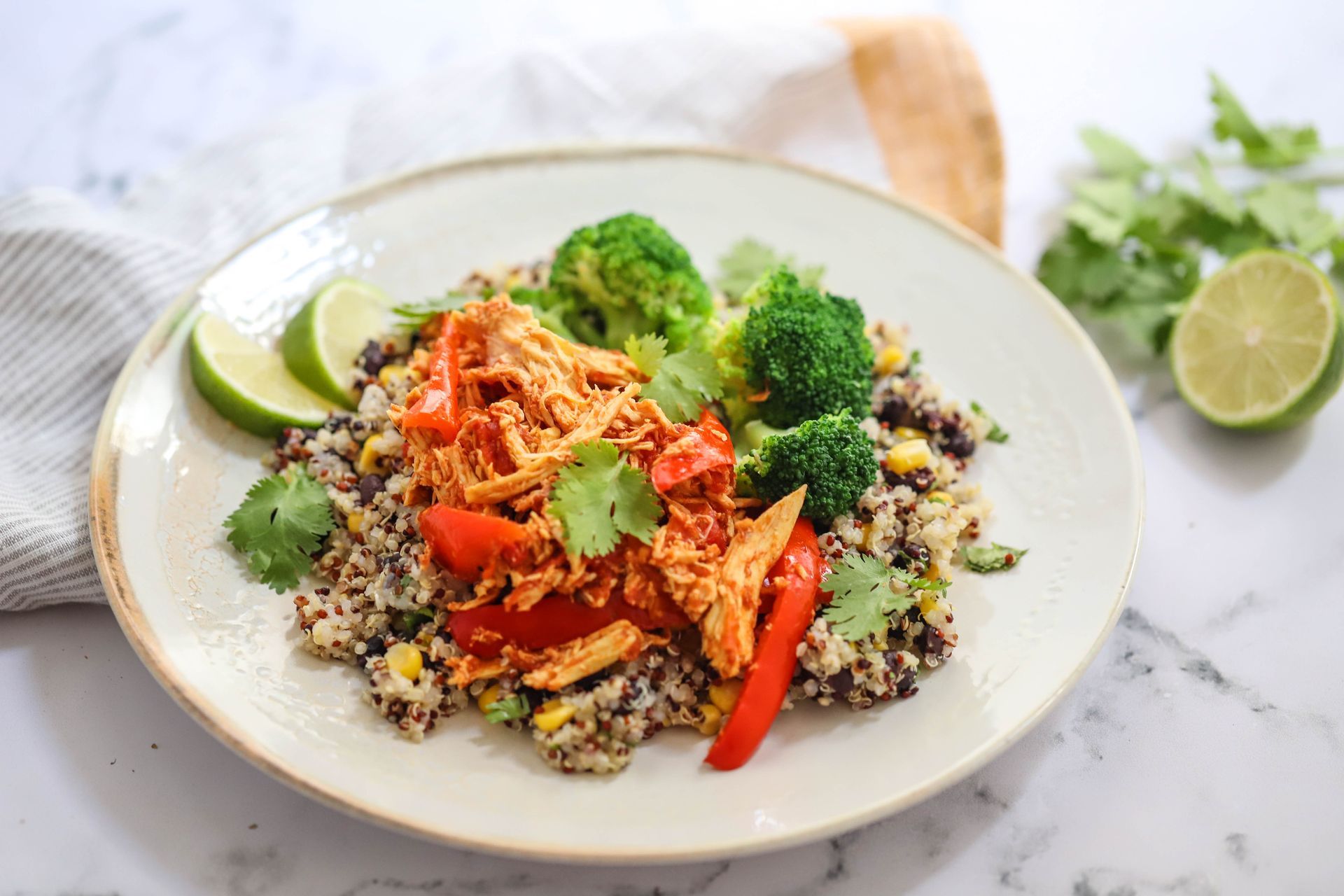 A white plate topped with rice , broccoli , and chicken.