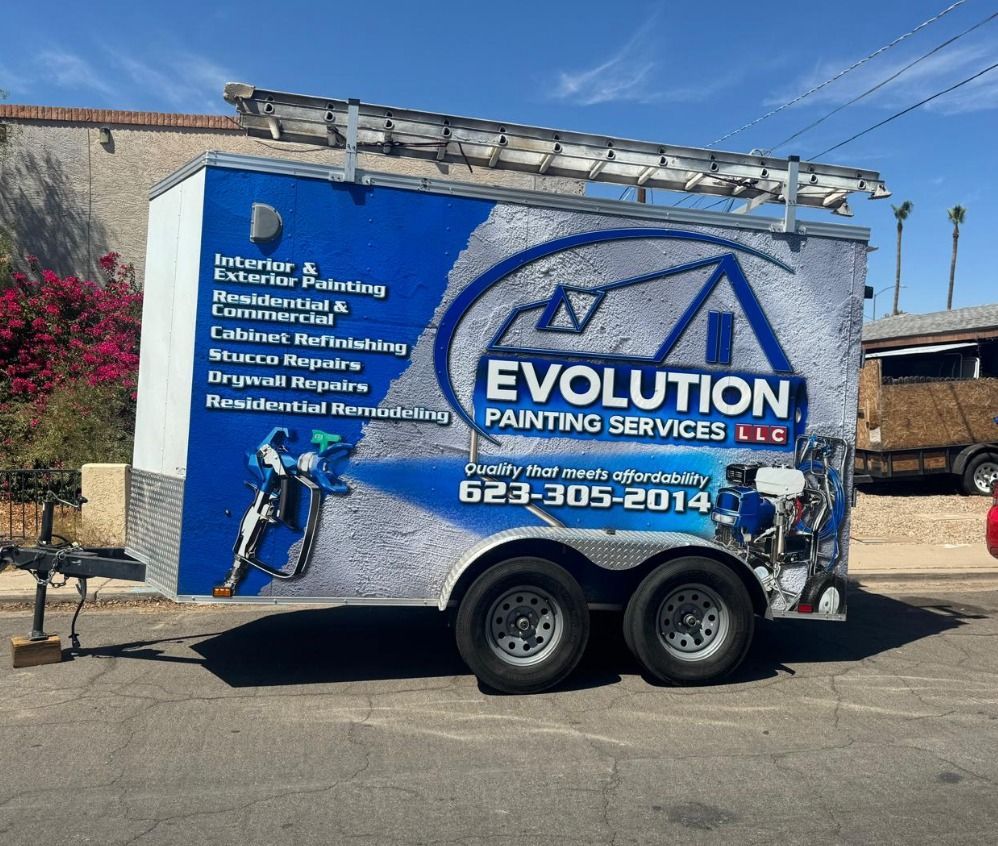 Blue Evolution Painting Services trailer with company logo and contact info parked outdoors.