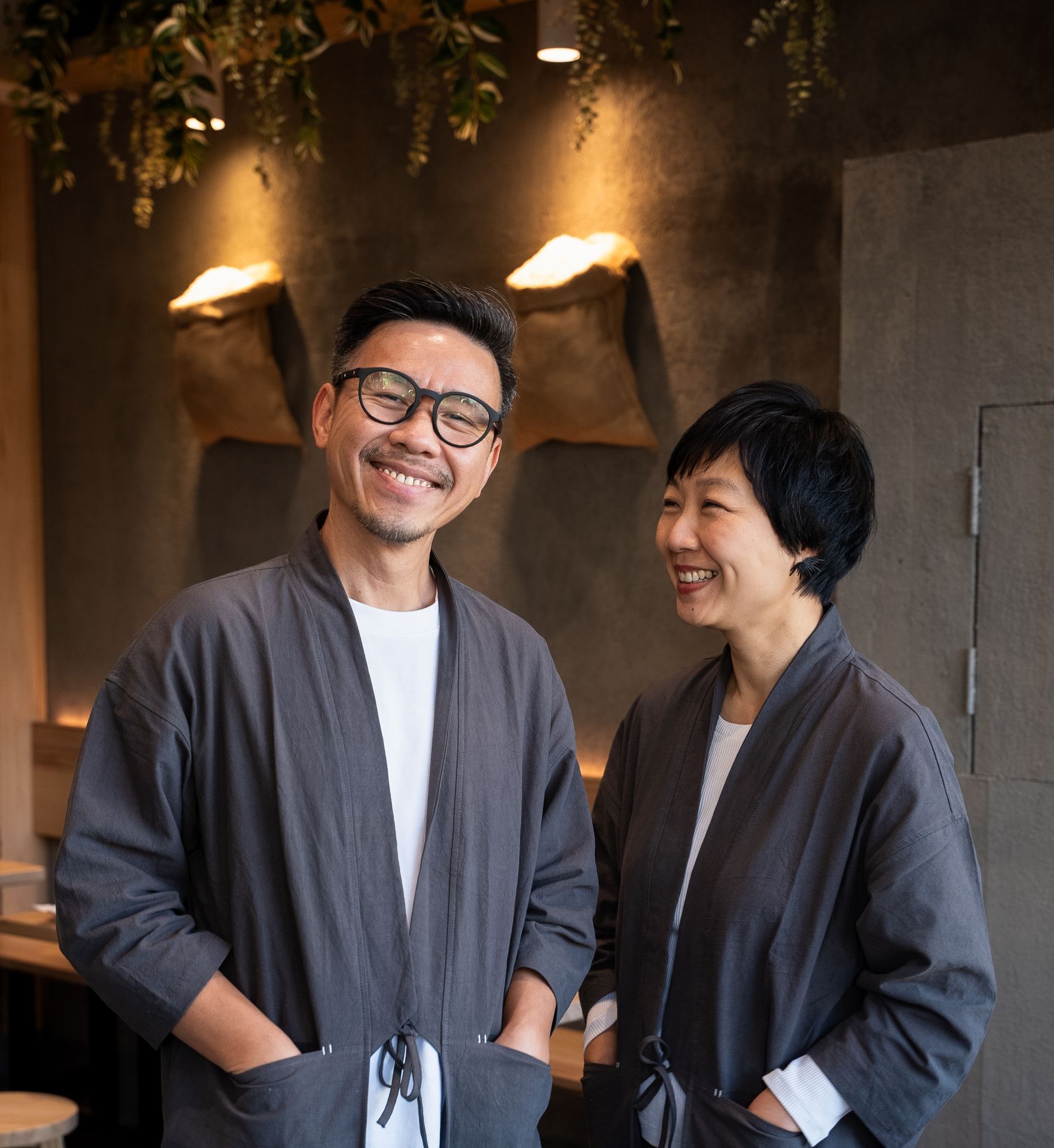 A man and a woman are standing next to each other and smiling.