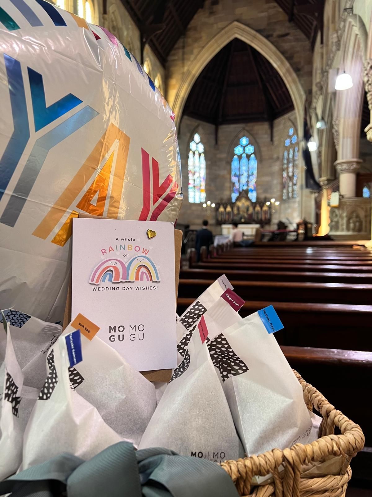 A balloon and a card are in a basket in a church.