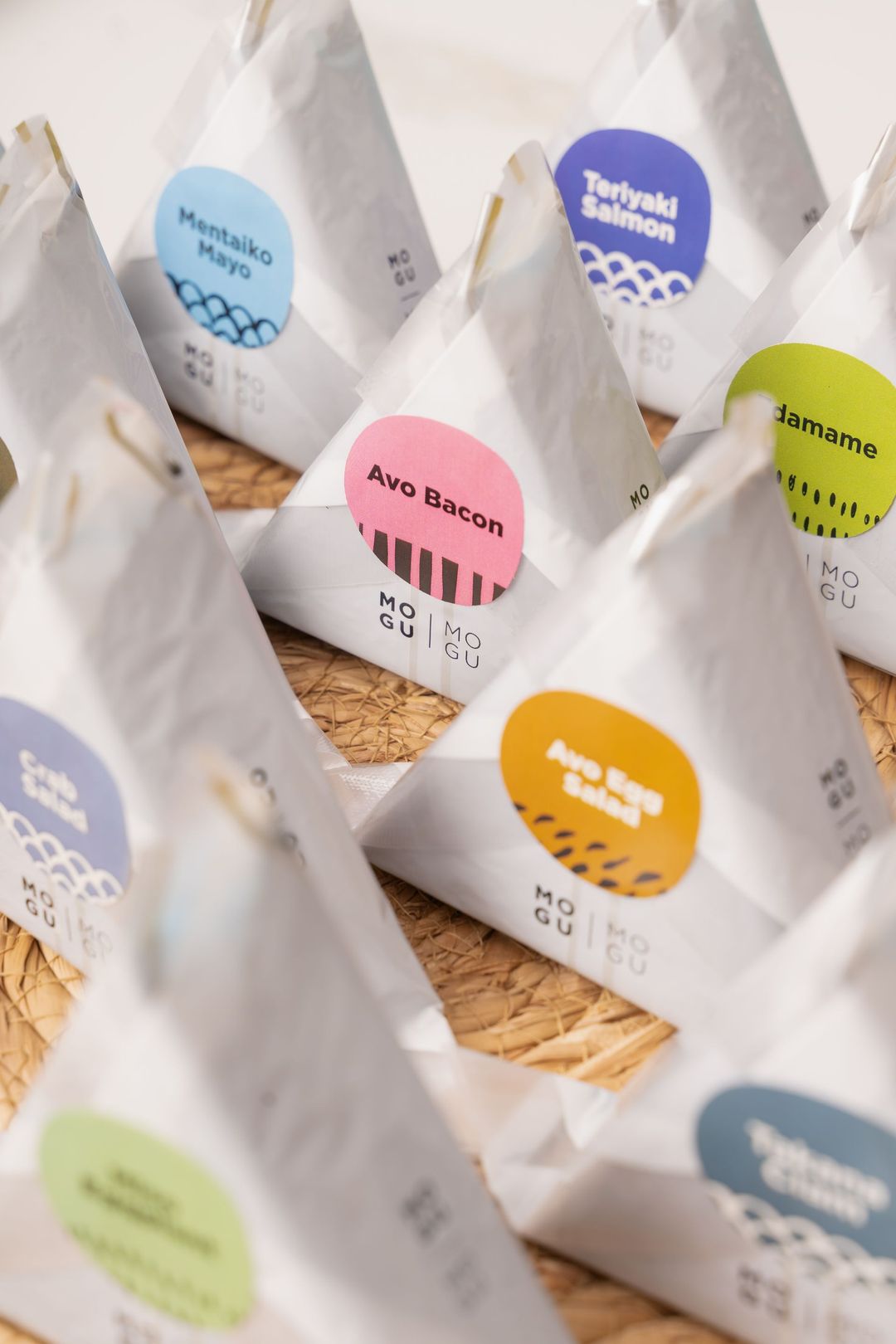 A bunch of white bags with different colored labels on them