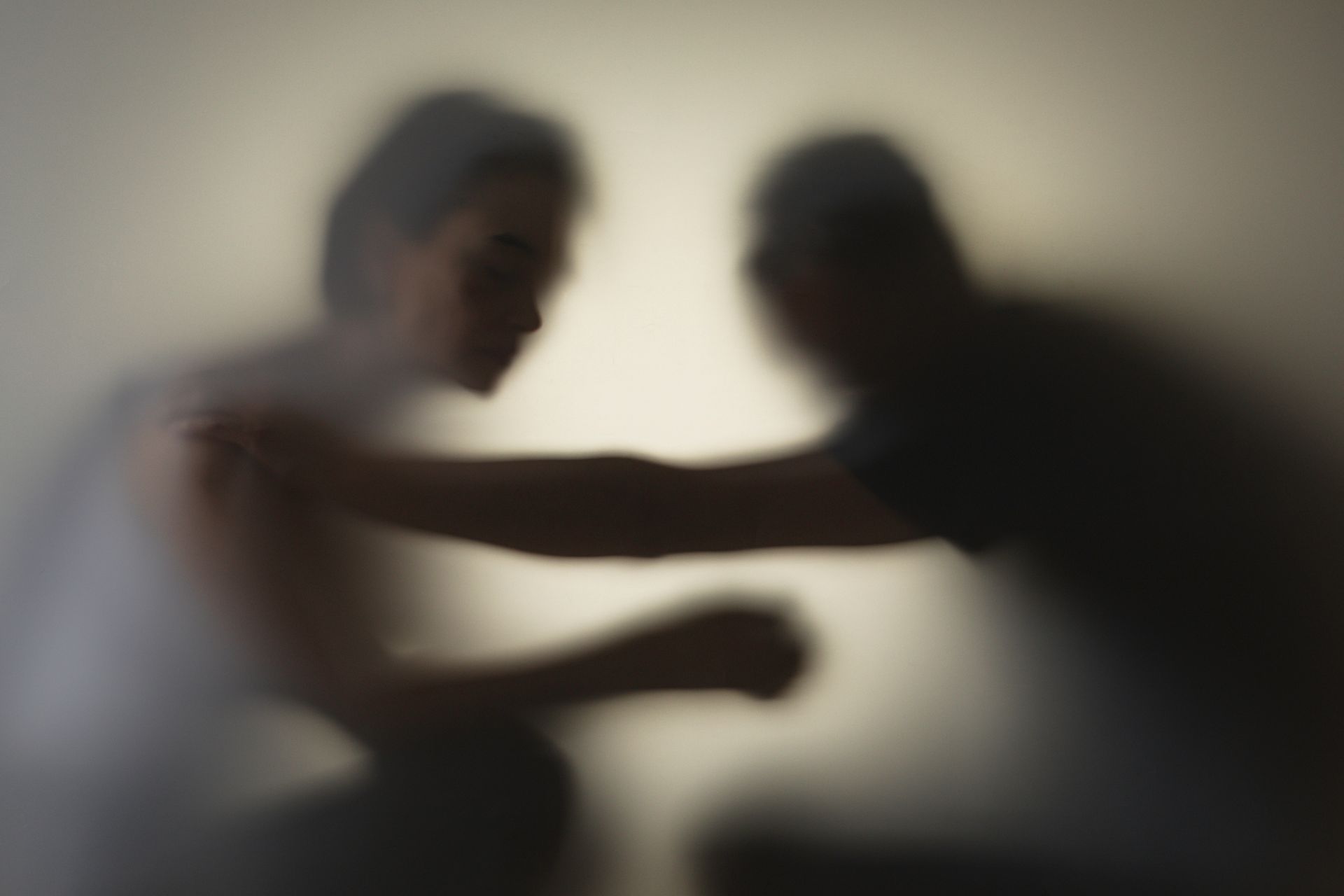 A blurry picture of two people standing next to each other.
