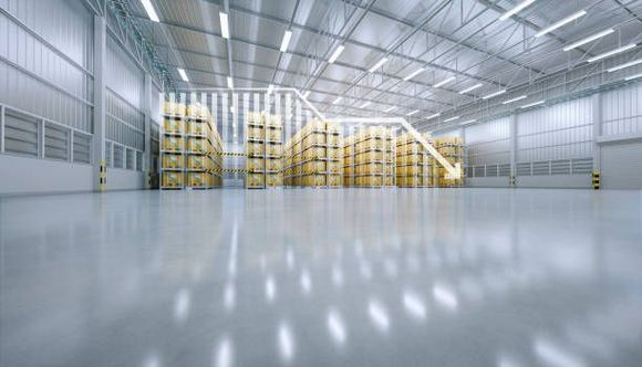 A large warehouse filled with lots of pallets and boxes.
