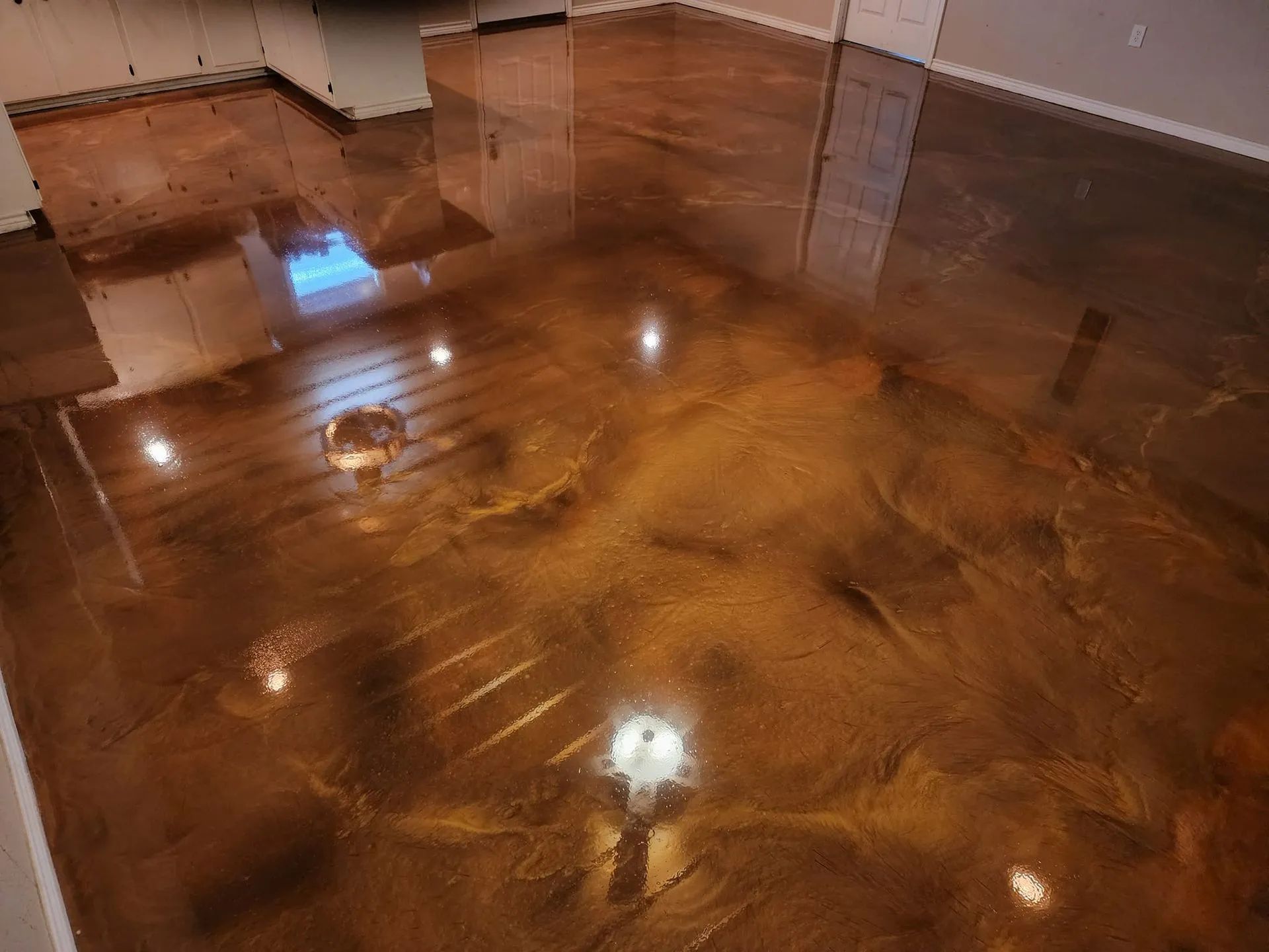 a room with a shiny metallic floor and a wooden floor