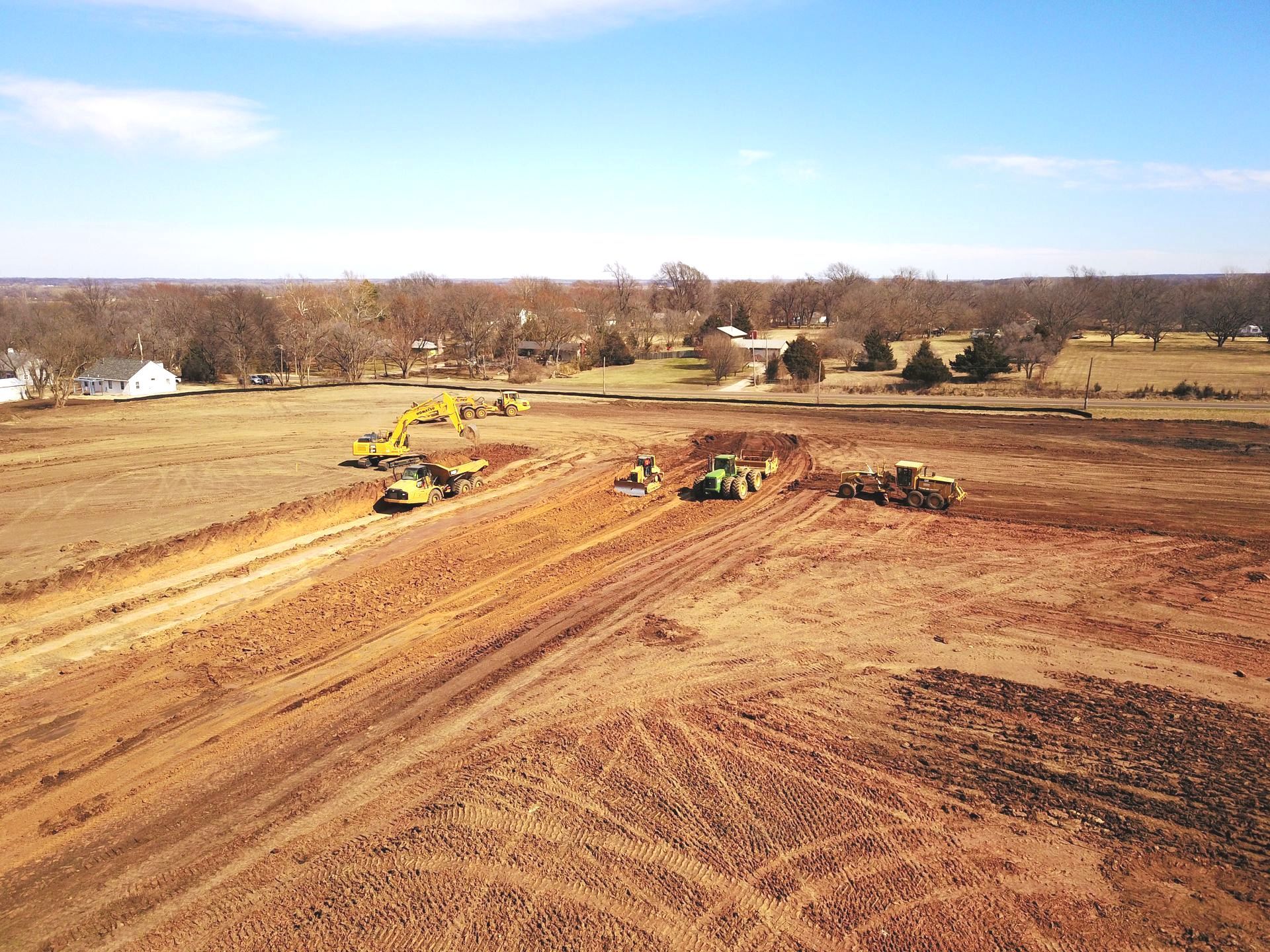 An aerial view of a construction site with tractors and bulldozers.