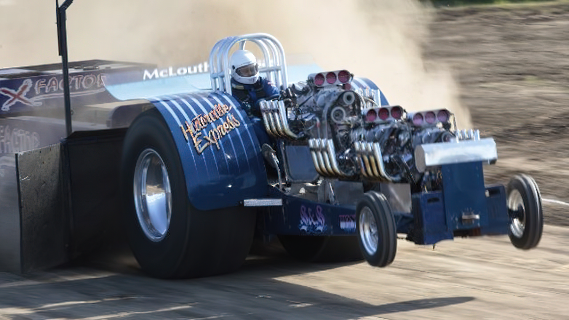 A hotrod care struggles to pull a something.